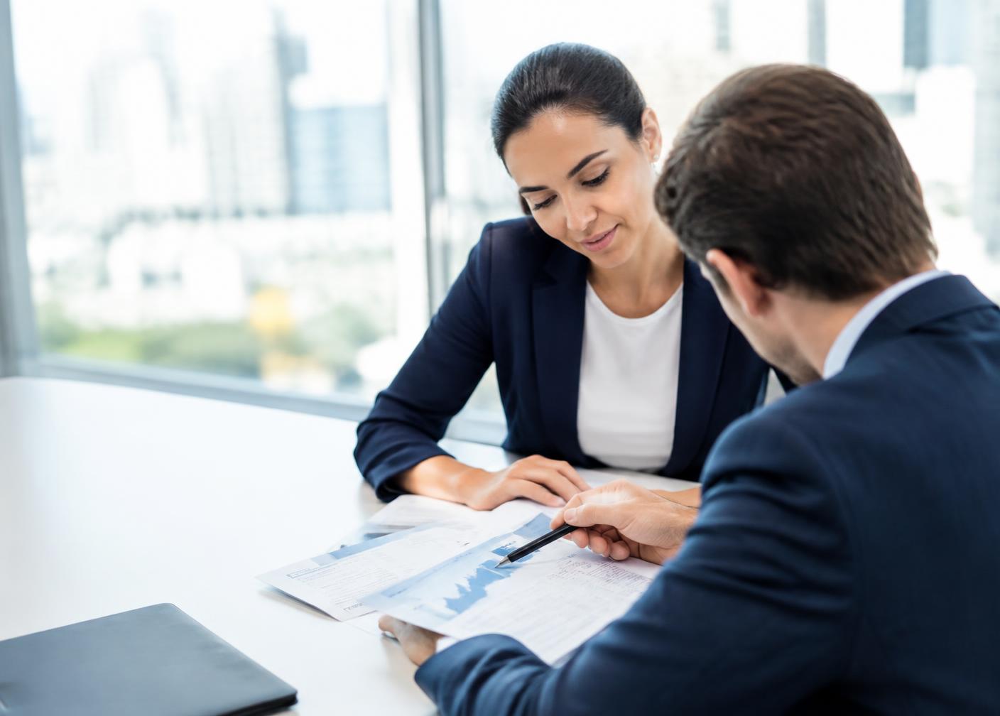 Two CDREAMZ consultants reviewing a client growth plan at a boardroom table