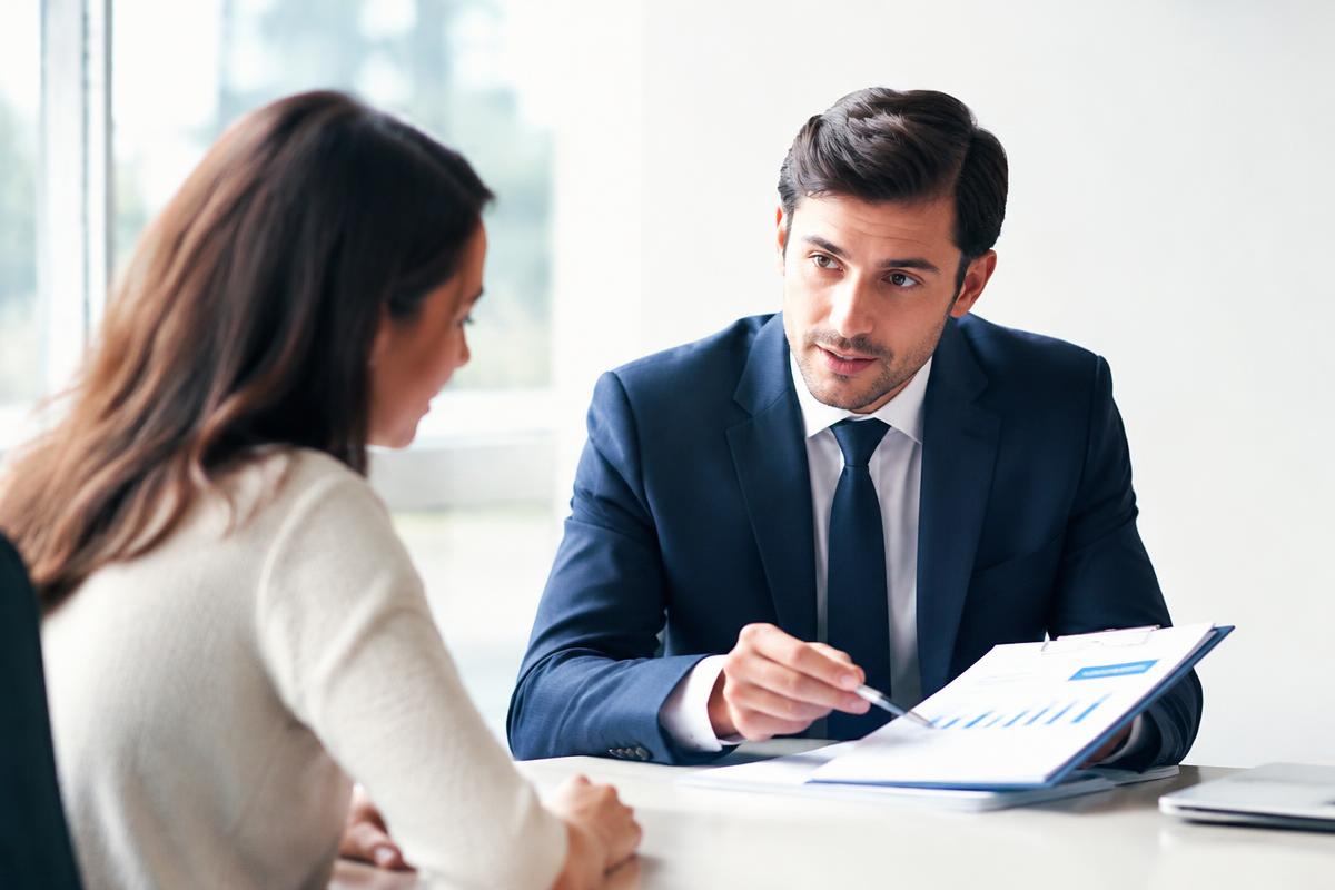 Advisor reviewing risk documents with a client in a bright office